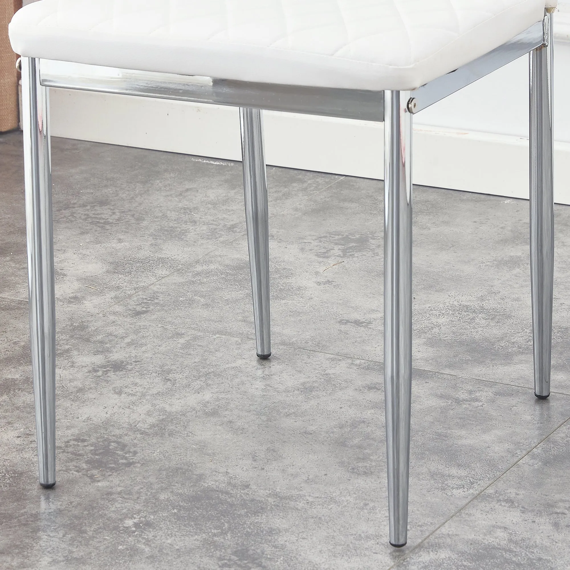 Table and chair set.Rectangular Dining Table with Tempered Glass Tabletop and Silver plating Metal Legs.Paired with 4 checkered armless high back white chairs with electroplated metal legs.
