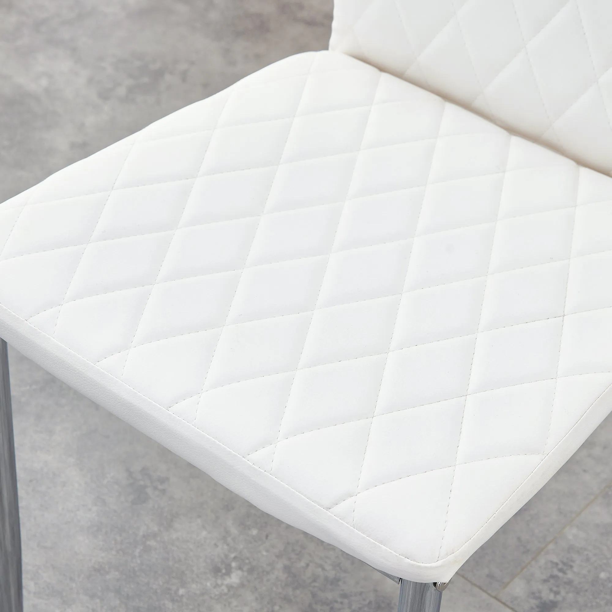 Table and chair set.Rectangular Dining Table with Tempered Glass Tabletop and Silver plating Metal Legs.Paired with 4 checkered armless high back white chairs with electroplated metal legs.